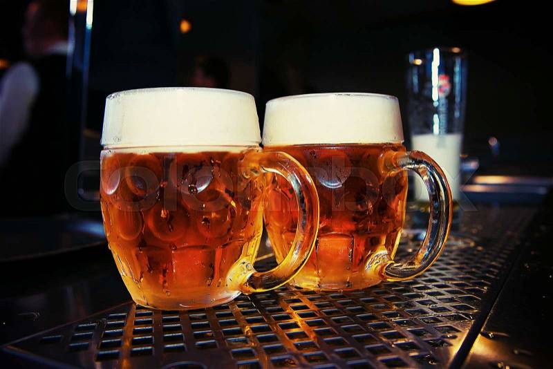 Big Beer glass on a bar table. Closeup, stock photo