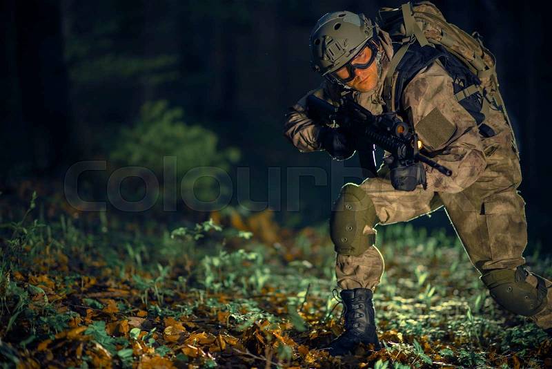 Night Time Special Operation. Running Troop Soldier with Assault Rifle at Night in the Forest, stock photo