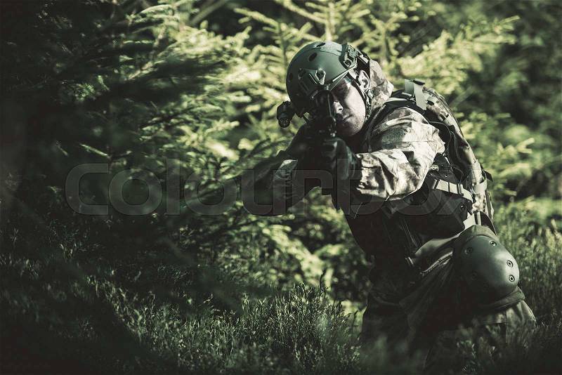 Special Forces Soldier. Camouflaged Marine Soldier Shooting Assault Rifle. Army Military Mission Concept Photo, stock photo
