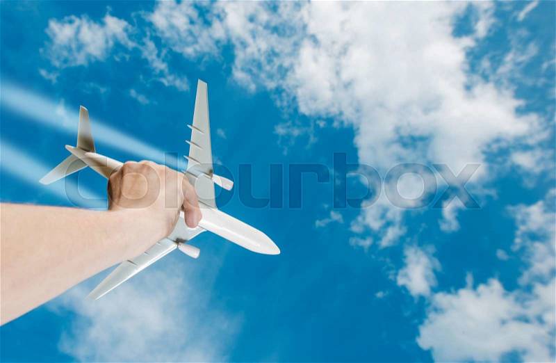 The Dream of Flight. Air Travel Idea Photo Concept with Airliner Airplane Model in a Hand. Business Flights, stock photo