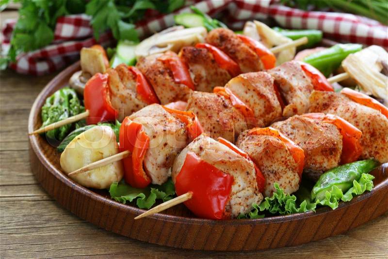 Chicken kebab with bell pepper on wooden skewers, stock photo