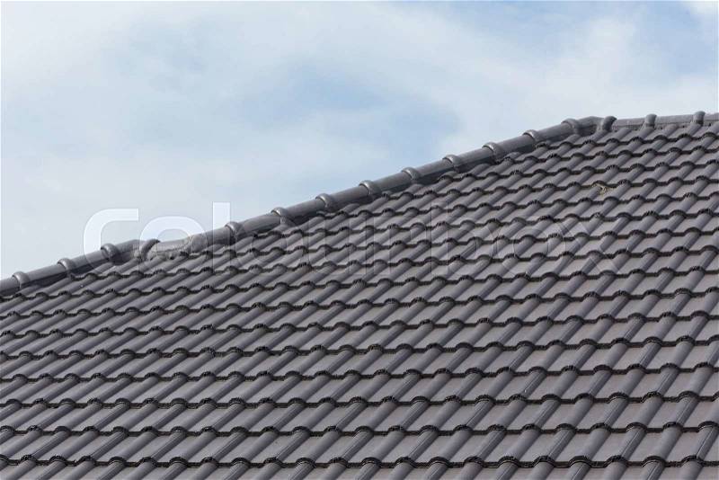 Black tile roof on a new house, stock photo