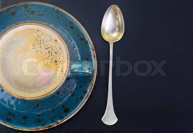 Coffee with milk, cappuccino in a blue retro cup. Studio Photo, stock photo