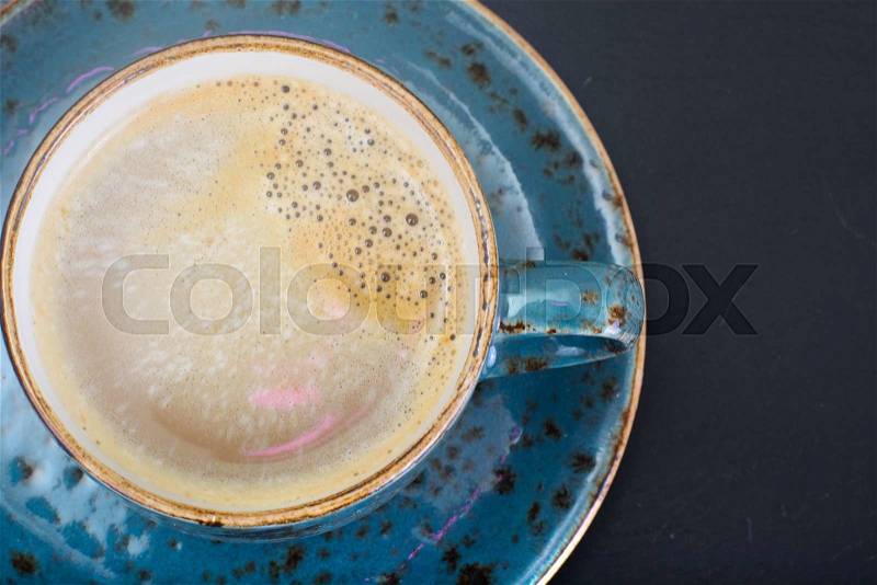 Coffee with milk, cappuccino in a blue retro cup. Studio Photo, stock photo