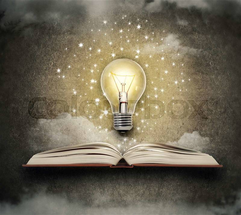 Glowing bulb above a book, stock photo