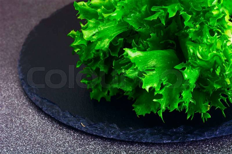 Healthy and diet food: green salad Isolated on Dark Background. Studio Photo, stock photo