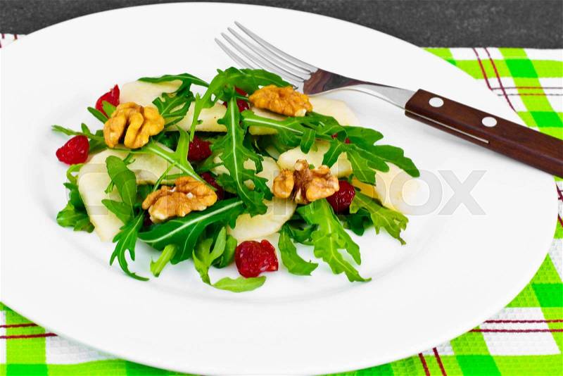 Dietary Delicious Salad on White Plate of Arugula, Par, Walnut and Dried Cherry. Studio Photo, stock photo