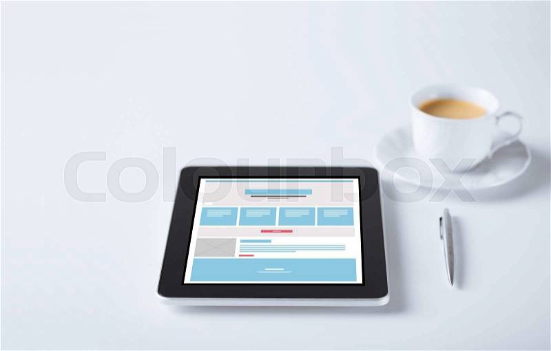 Business and technology concept - close up of tablet pc computer with web page design template and cup of coffee, stock photo