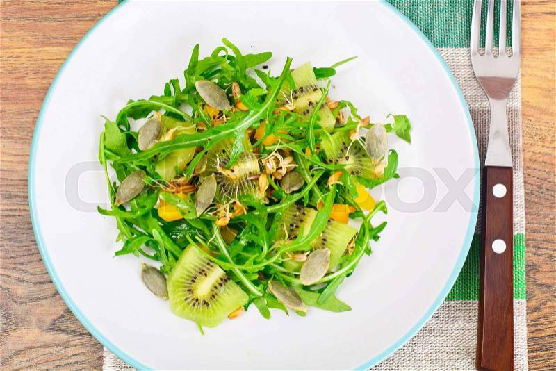 Salad from Grown Wheat, Arugula, Pumpkin Seeds with Sweet Pepper and Kiwi Studio Photo, stock photo