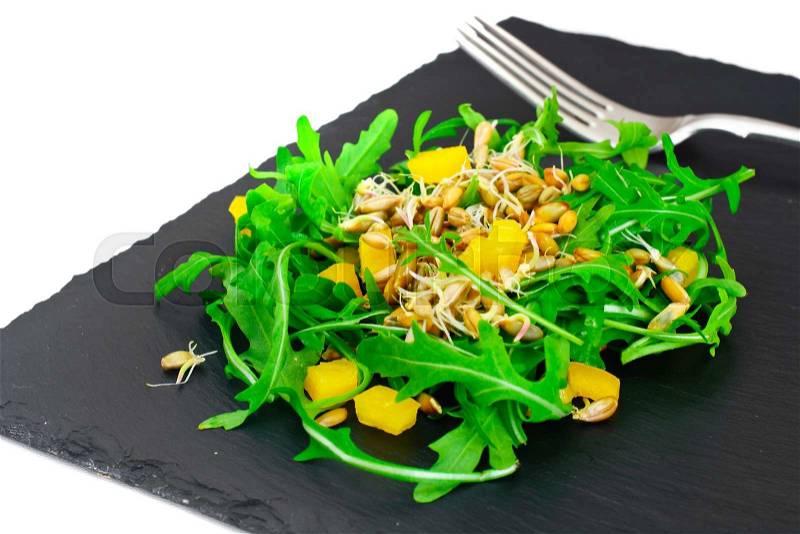 Salad from Grown Wheat, Arugula, Pumpkin Seeds with Sweet Pepper and Kiwi Studio Photo, stock photo