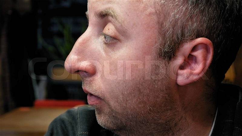 Pensive friendly man emotional close portrait with big expressive eyes significant nose and small stubble beard. Friendly silent reflection thoughtful scene. , stock photo