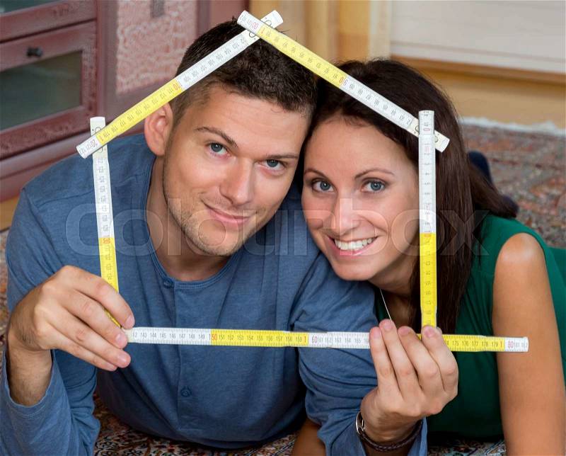 A young couple is looking forward to the construction of a detached house, stock photo