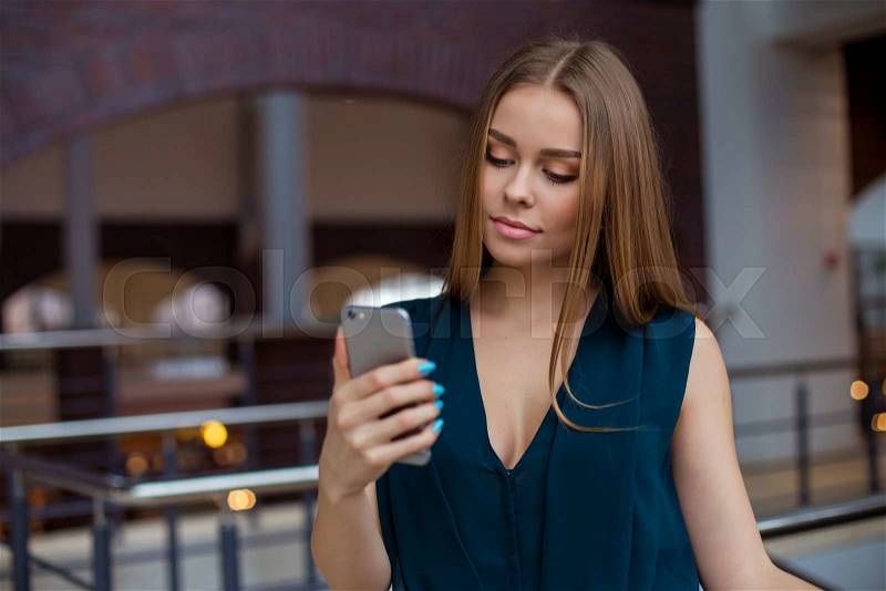 Beautiful woman in casual clothes is making a selfie using a smart phone, stock photo