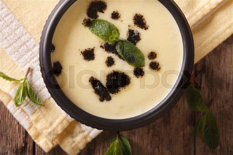 Turkish Yayla soup with rice, mint and yoghurt in a bowl close-up on the table. horizontal view from above , stock photo