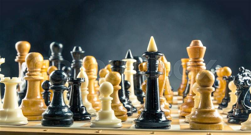 Many chess figures standing on the board, stock photo