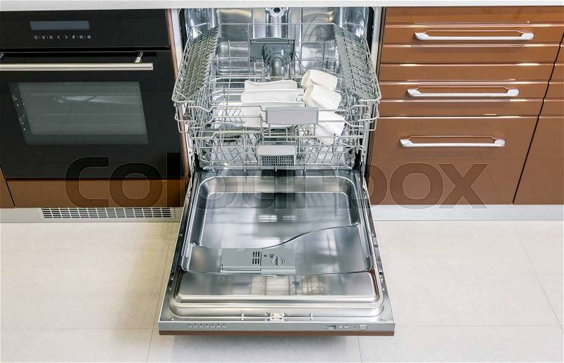 Clean dishes in open dishwasher machine, stock photo