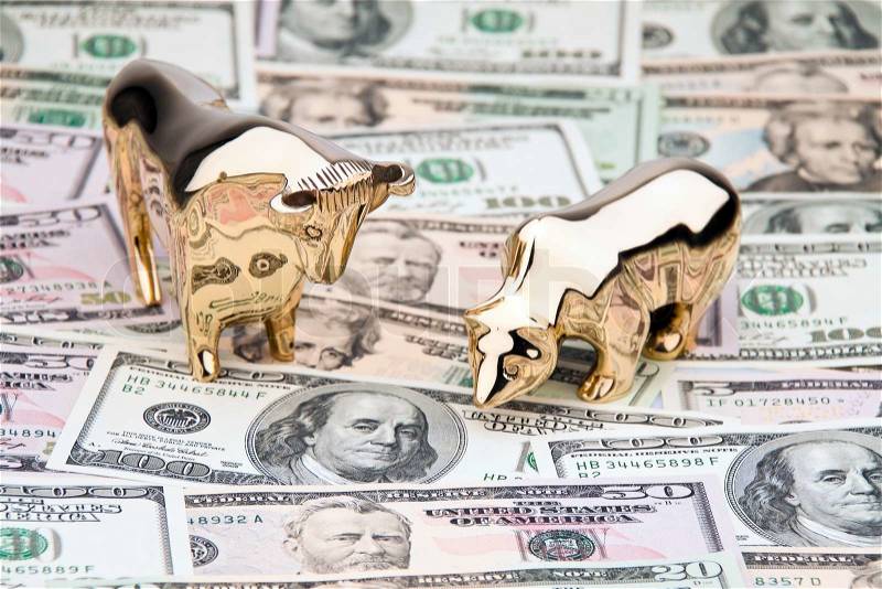 Many dollar bills with bull and bear. Investment in shares, stock photo