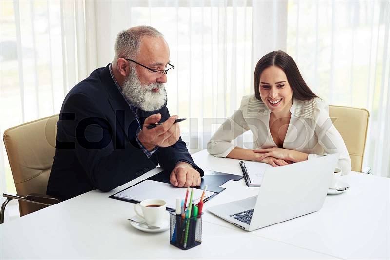 Young businesswoman consulting new business plans with her colleague, stock photo