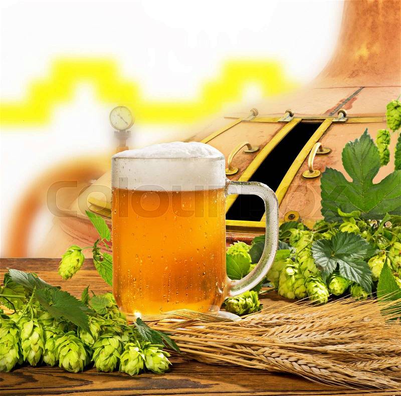 Glass of beer with hops and barley in the brewery, stock photo