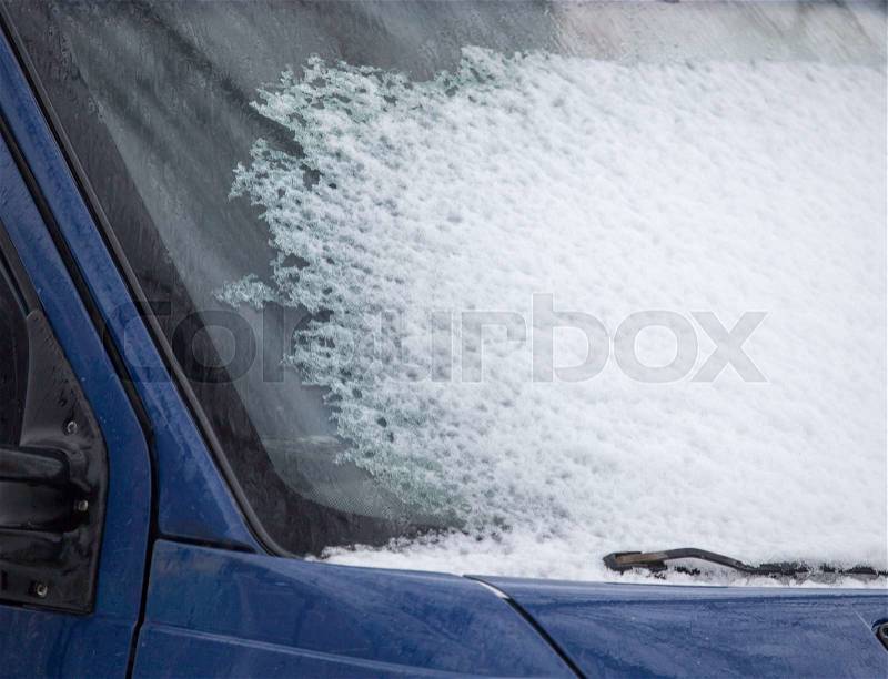 Snow on the window of car in winter, stock photo