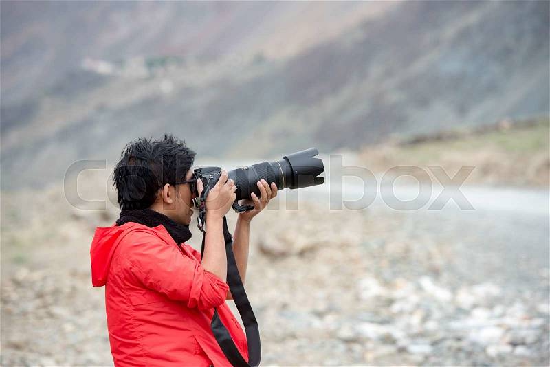 ZANSKAR, INDIA - JULY 15, 2015 : Untitled photographer taking photo from Himalayan Mountain, Zanskar, North India, stock photo