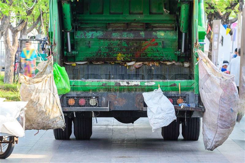 Garbage truck keeping garbage on urban street. , stock photo