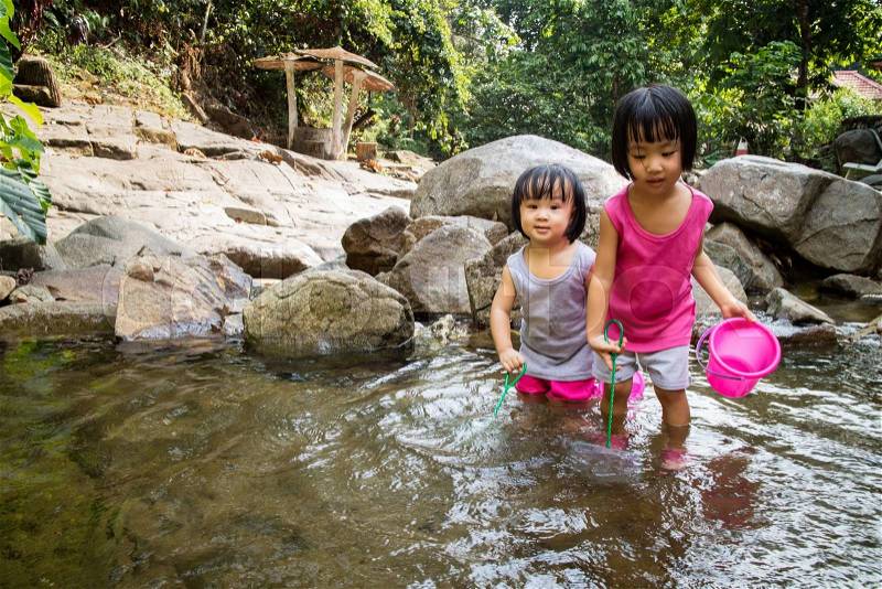 Asian Little Chinese Girls Playing in Creek in the Forest, stock photo