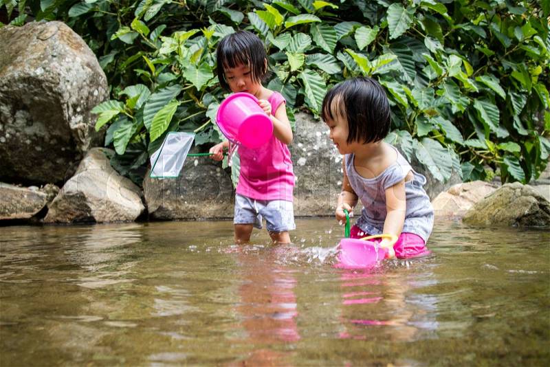 Asian Little Chinese Girls Playing in Creek in the Forest, stock photo