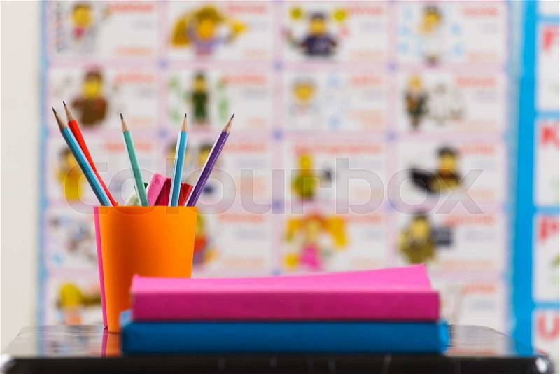 Pencils and book on table , stock photo