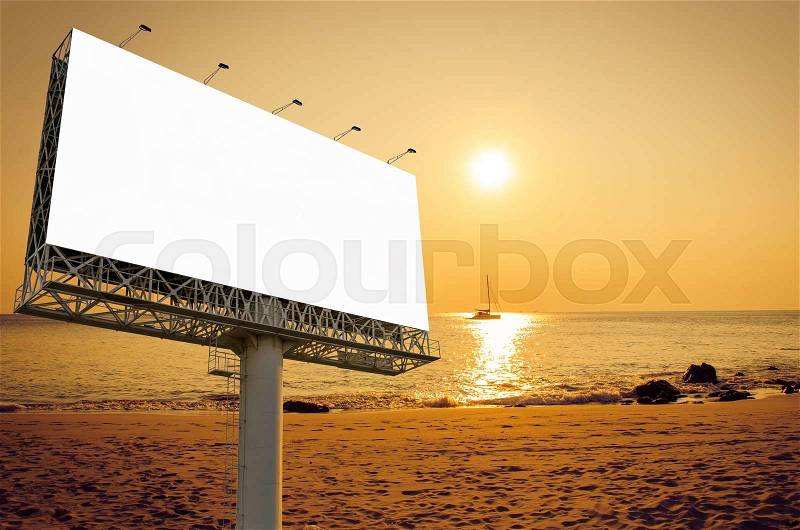 Blank billboard ready for new advertisement on the beach with sunset, stock photo
