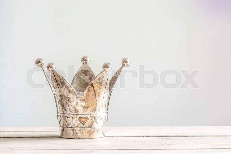 Princess crown with hearts on a wooden table, stock photo