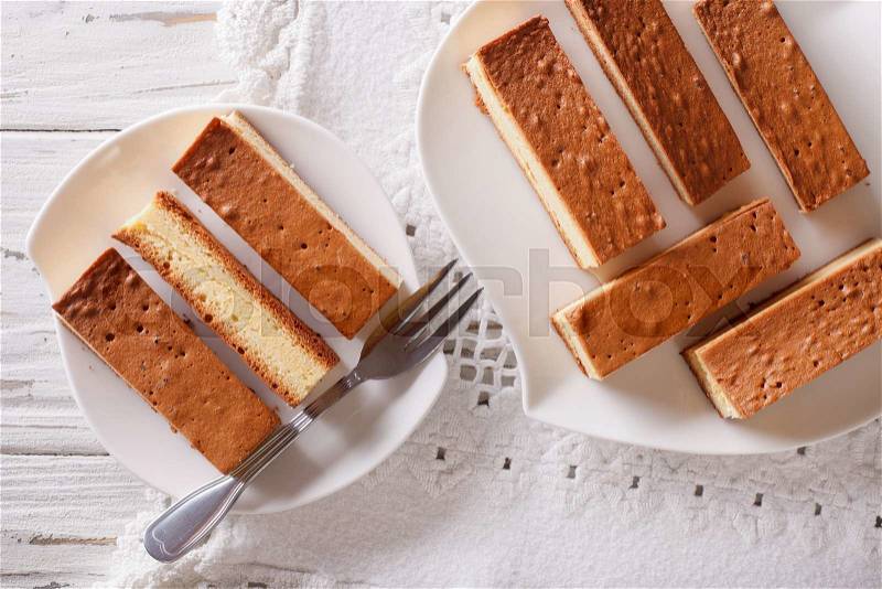 Castella Japanese cake on a plate closeup on the table. Horizontal view from above , stock photo