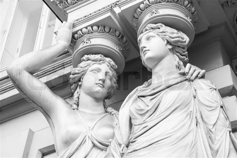 Caryatid. Statues of two young women in form elegant columns supporting a portico, Josefsplatz, Vienna. Black and white photo, stock photo
