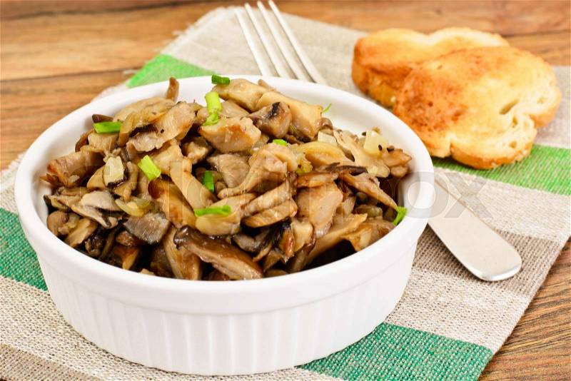 Fried Mushrooms with Onions, Bruschetta, Croutons, Chives Studio Photo, stock photo