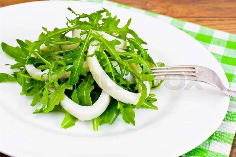 Arugula Salad with Squid, Flax Seeds, Olives and Cherry Tomatoes Studio Photo, stock photo