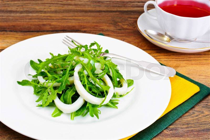 Arugula Salad with Squid, Flax Seeds, Olives and Cherry Tomatoes Studio Photo, stock photo