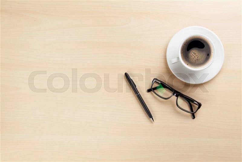 Office desk table with coffee cup, pen and glasses. Top view with copy space, stock photo