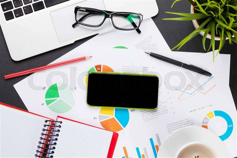 Office leather desk table with laptop, coffee cup, smartphone and reports. Top view with copy space, stock photo