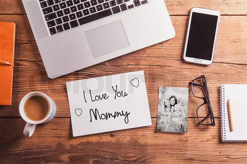 Mothers day composition. I love you Mommy note and black-and-white photo. Office desk. Studio shot on wooden background, stock photo