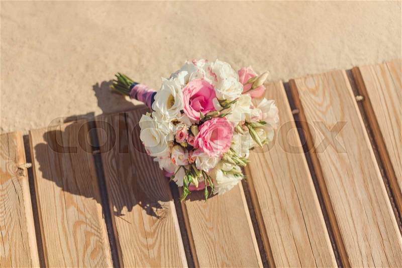 Bride\'s Pink and White Bouquet Laying on Pier. Wedding in Tropical Country Idea, stock photo