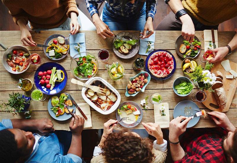 Group of young people eating dinner, stock photo