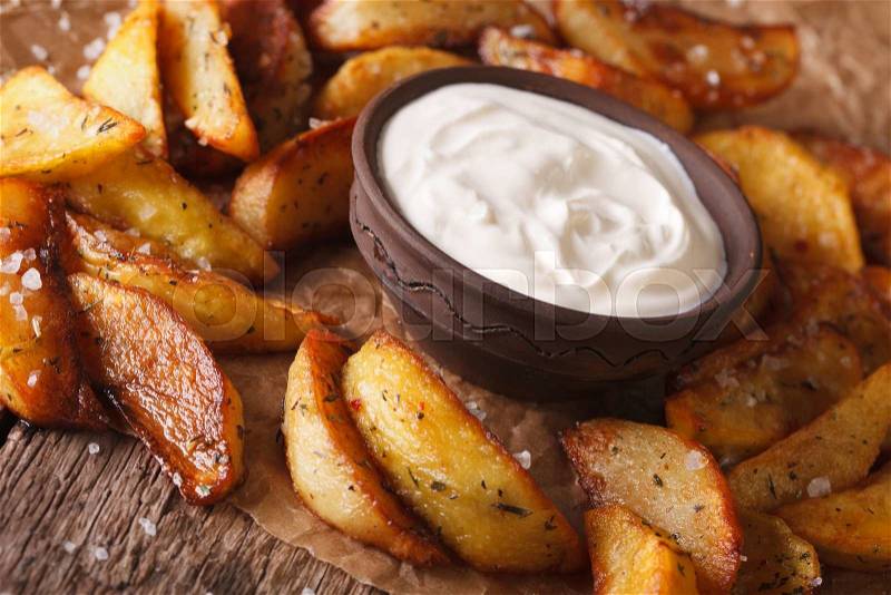 Fast food: Potato wedges and mayonnaise close-up on the table. horizontal , stock photo
