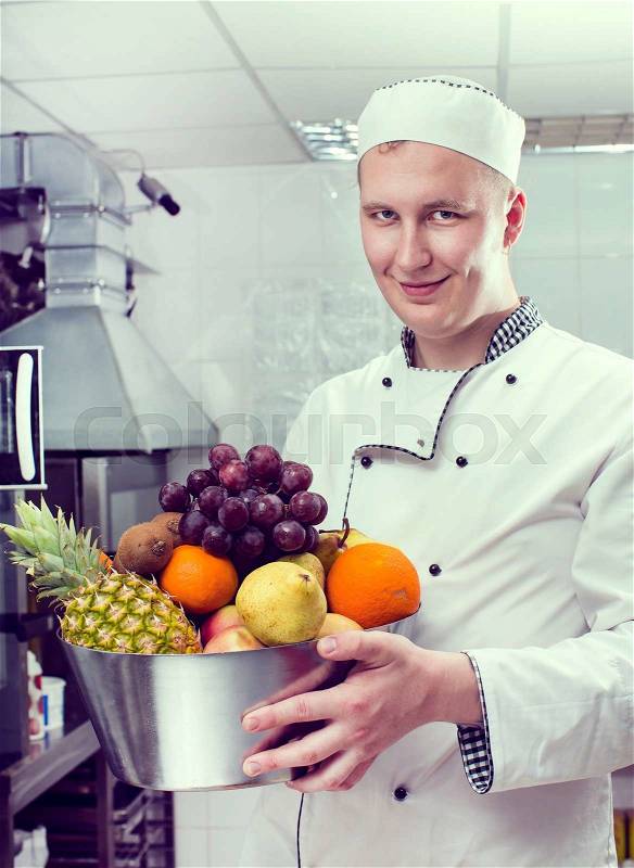 Chef preparing food in the kitchen at the restaurant, stock photo