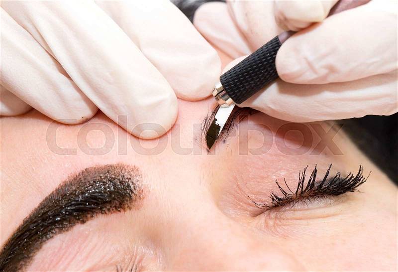 Mikrobleyding eyebrows workflow in a beauty salon, stock photo