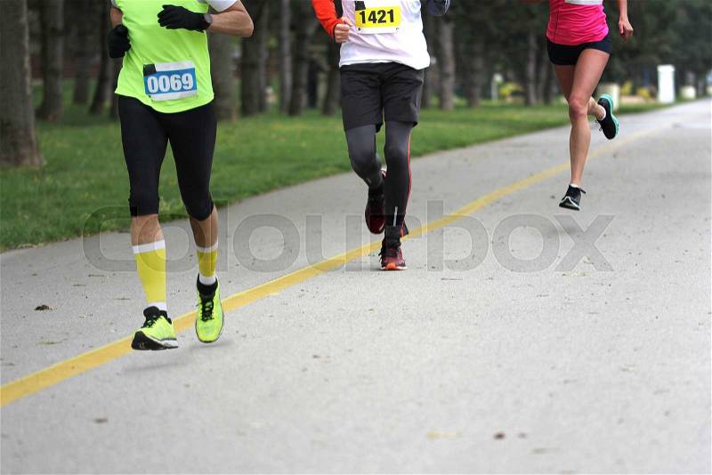 Three people running Cross country Marathon, Blured Motion , stock photo