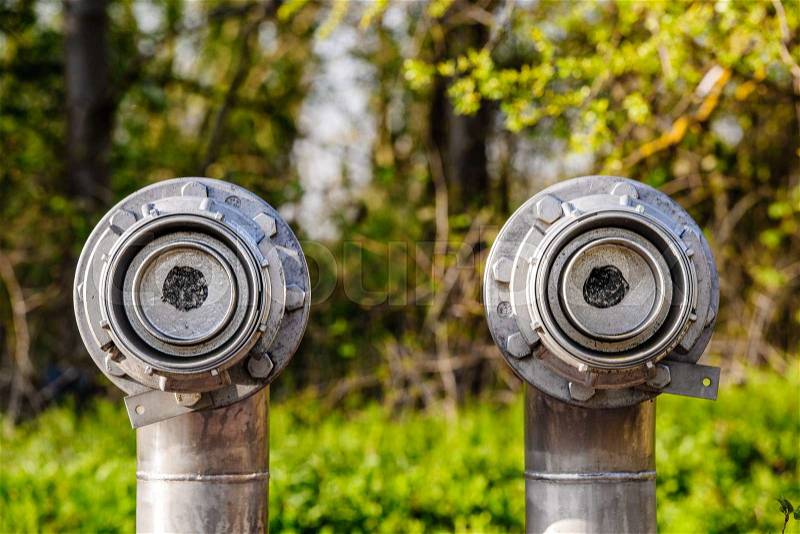 Two oil and gas pipes closed in the middle of the forest for environmental protection reason, stock photo