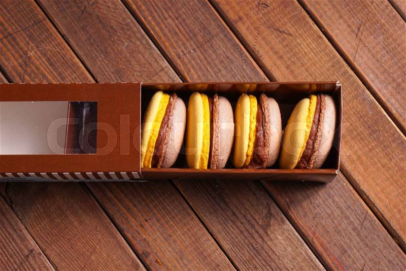 Macaroons cakes in box. delicious beige and yellow macaroon, stock photo