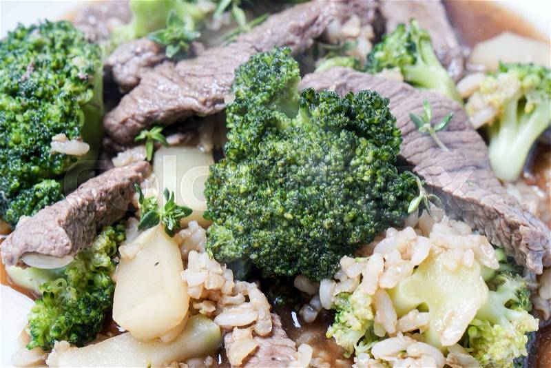 Healthy Beef and Broccoli stir fry served on a white plate, stock photo