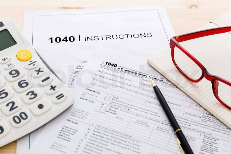 Income tax income return form and instruction with calculator and pen, stock photo