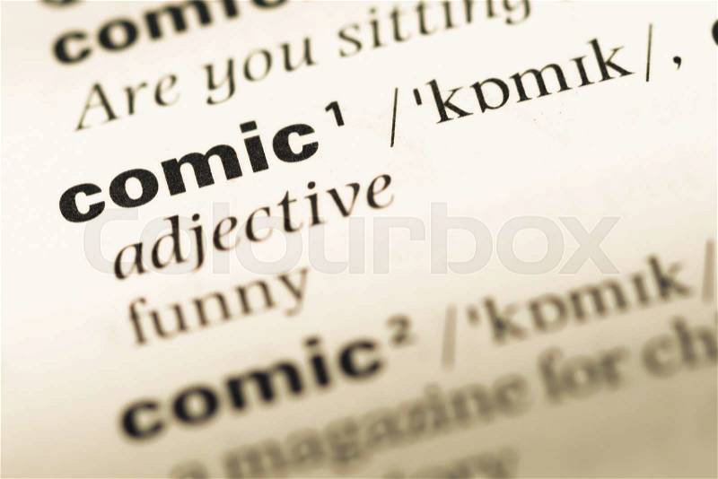 Close up of old English dictionary page with word comic, stock photo